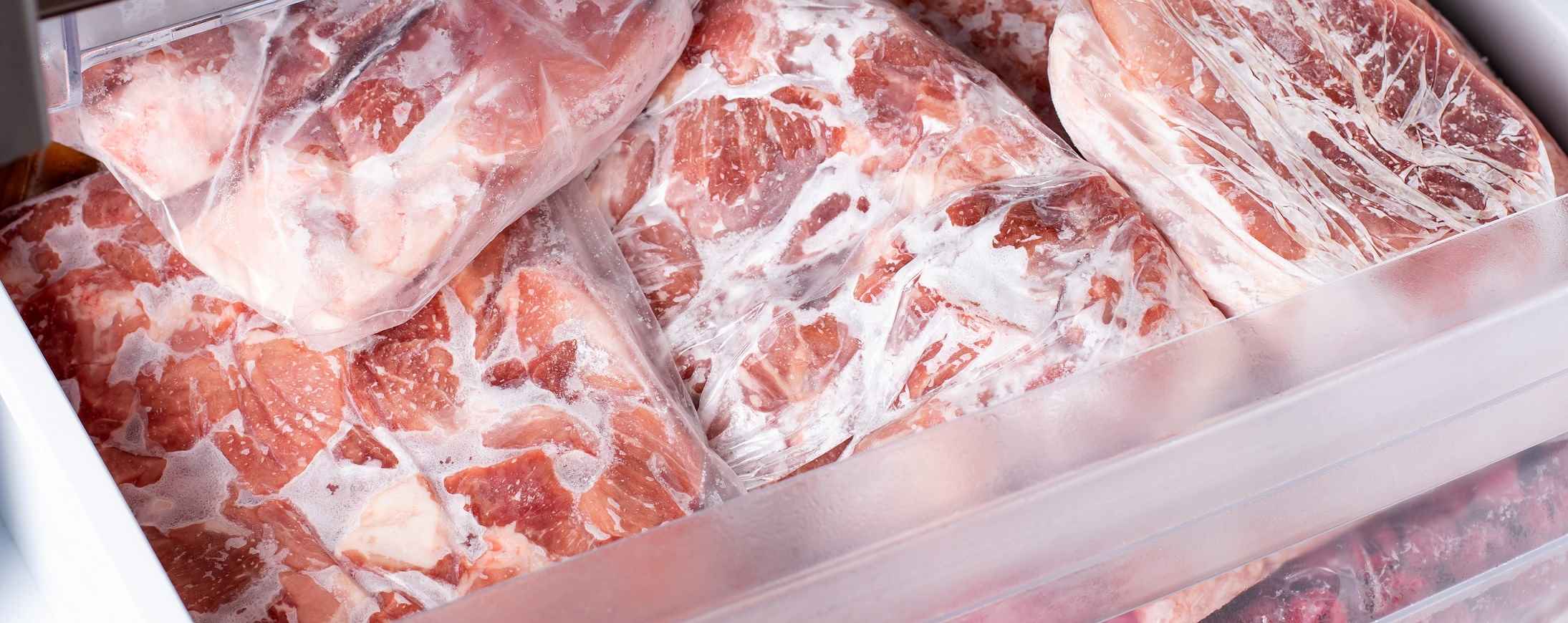 Raw frozen meat in the freezer in bags
